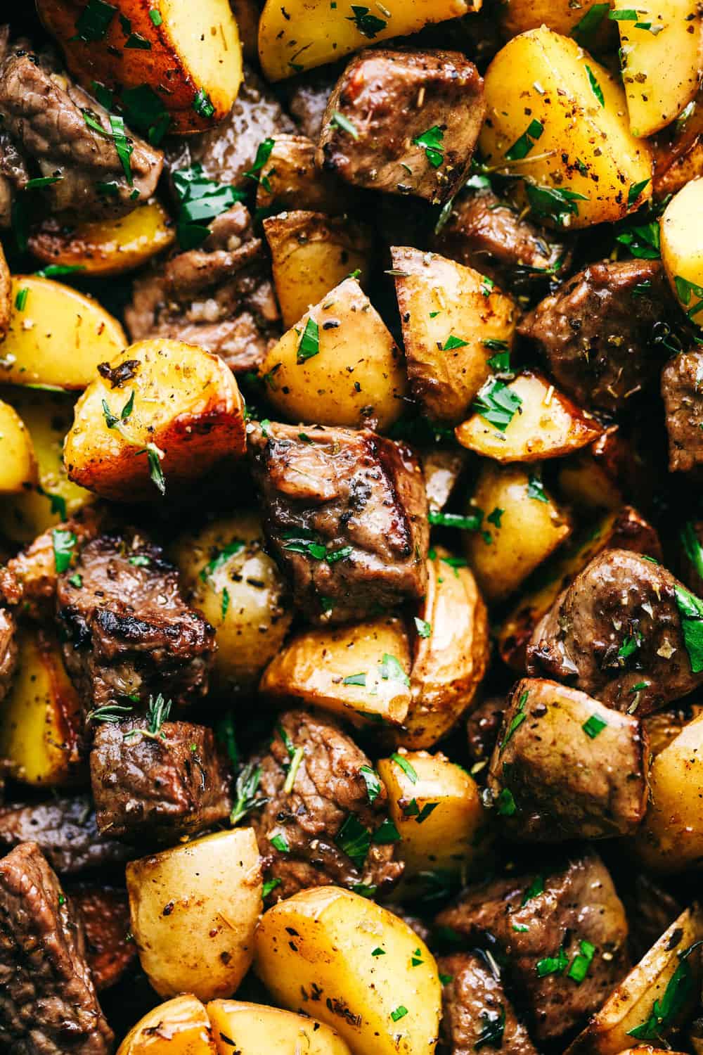 Close up shot of garlic butter steak bites and potatoes. 